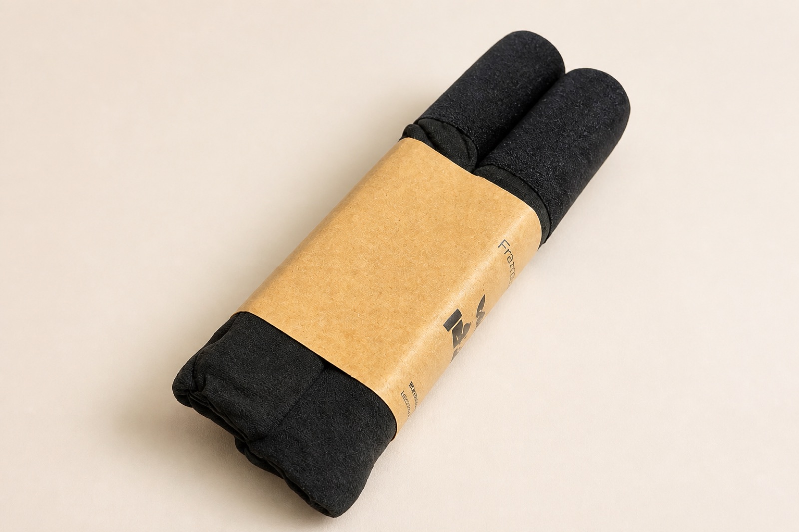 Close view of a kraft cardboard sleeve around folded black underwear